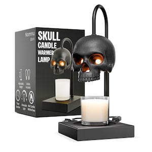 May include: A black skull-shaped candle warmer lamp with a rectangular base and a curved arm. The lamp features a textured skull head that houses a light bulb, positioned above a glass candle. The packaging box displays the text Nomnu dark SKULL CANDLE WARMER LAMP.