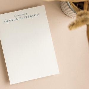May include: A white notepad with the text "from the desk of AMANDA PATTERSON" printed in blue at the top.