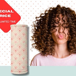 May include: A neck gaiter with a repeating floral pattern in peach and cream. The words "SPECIAL PRICE" are on a red tag. The background is white with small pink polka dots. A person with curly brown hair is in the background.
