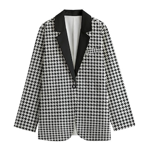 May include: A black and white houndstooth blazer with a black lapel and a single button fastening. The blazer has long sleeves and a white interior.