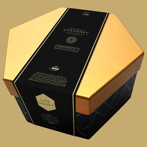 May include: A gold hexagonal box with a black label that says "LIFEHONEY" and "BEREAVEMENT KIT". The box is decorated with a sun and a gold honeycomb pattern.