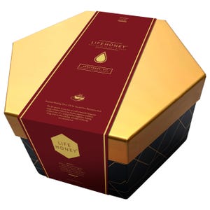 May include: A hexagonal gift box with gold and black geometric designs. A burgundy band wraps around the box, featuring the text "LIFEHONEY" and "NEWLYWEDS KIT". The box is designed for a wedding gift.