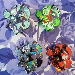 May include: Four enamel pins featuring a black and white creature with a scythe and flames. The pins are in different color schemes: green, blue, black, and red.
