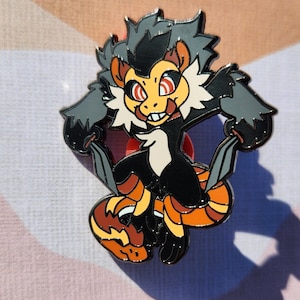 May include: A black and orange enamel pin featuring a cartoon character with a mischievous expression. The character has a black body, orange and yellow striped legs, and a gray and white head with red eyes.