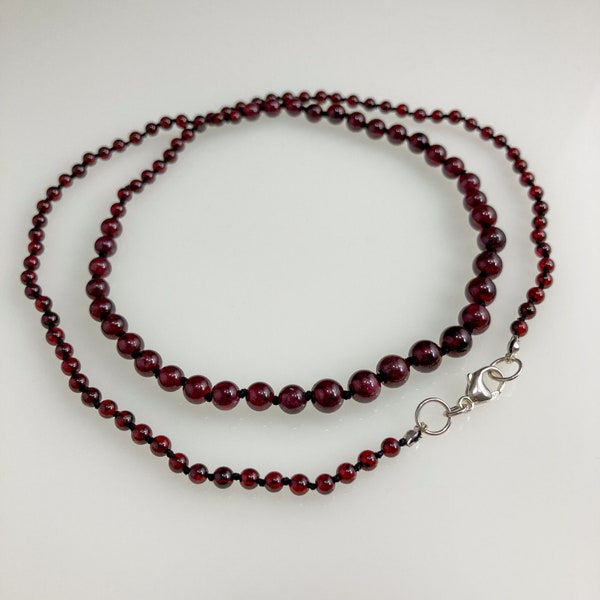 Hand-knotted Graduated Garnet Necklace on black silk cord with sterling silver clasp