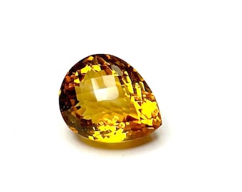 May include: A teardrop-shaped, faceted gemstone with a golden yellow color.