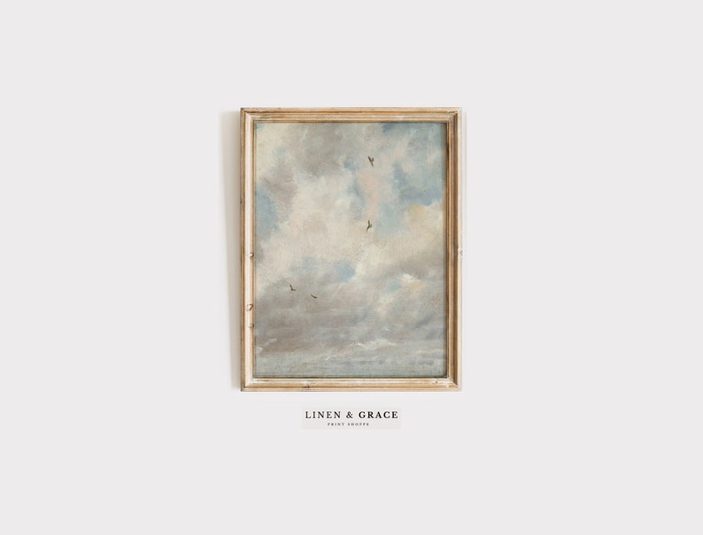 May include: A framed painting depicting a cloudy sky with birds flying in formation. The sky is a light blue with white clouds. The painting is in a simple wooden frame.