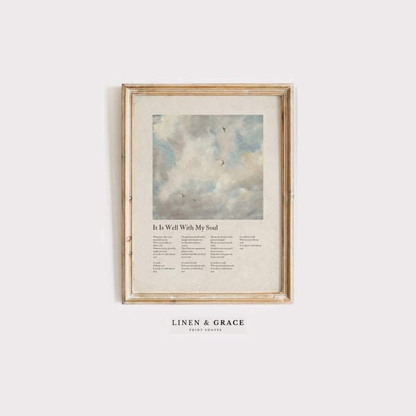 May include: A framed print with a light blue and white watercolor sky with birds flying. The print has the text "It Is Well With My Soul" and the lyrics to the hymn. The frame is a light wood color. The print is from Linen & Grace Print Shop.