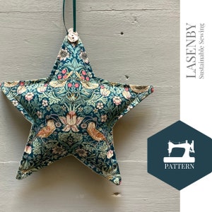 May include: A teal blue star-shaped pillow with a floral and bird print. The pillow has a button closure and is hanging from a string. The text "LASENBY Sustainable Sewing" and "PATTERN" are visible in the image.