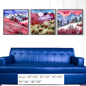 May include: Three framed watercolor landscape paintings. Each features a mountain scene with red, blue, and green hues. The paintings are displayed above a blue sofa. The available sizes are 10"x10", 12"x12", 14"x14", 16"x16", and 18"x18".