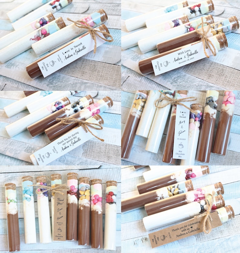 May include: Assortment of small glass test tubes filled with colorful candies, marshmallows, and chocolate powder. Each tube is tied with twine and a personalized tag with the text "Love is Sweet" and the names "Andrea & Gabrielle".