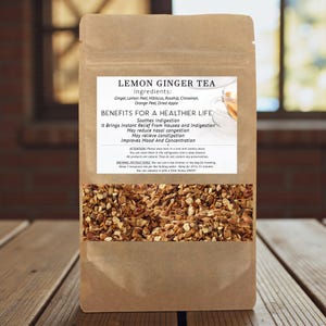 May include: A brown paper bag of Lemon Ginger Tea with a clear window displaying the tea blend. The label lists ingredients: ginger, lemon peel, hibiscus, rosehip, cinnamon, orange peel, and dried apple. The label also lists health benefits.