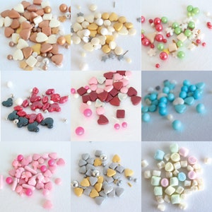 May include: Assortment of colorful sprinkles in various shapes, including hearts, stars, and squares. The sprinkles are perfect for decorating cakes, cupcakes, and other desserts.