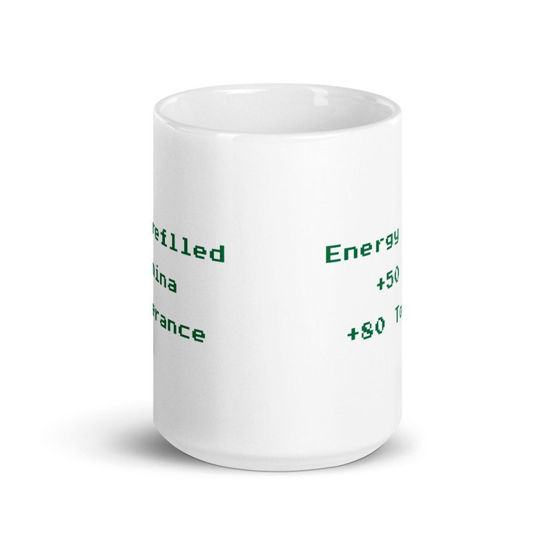 May include: White ceramic mug with green text that reads "Refilled", "China", "France", "Energy", "+50", and "+80". The mug is cylindrical and has a glossy finish.
