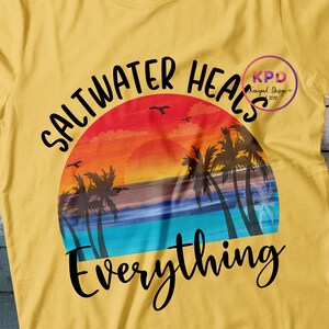 K&ouml;nnte beinhalten: Gelbes T-Shirt mit einem Retro-Sonnenuntergang-Motiv und dem Text "Salzwasser heilt alles".
