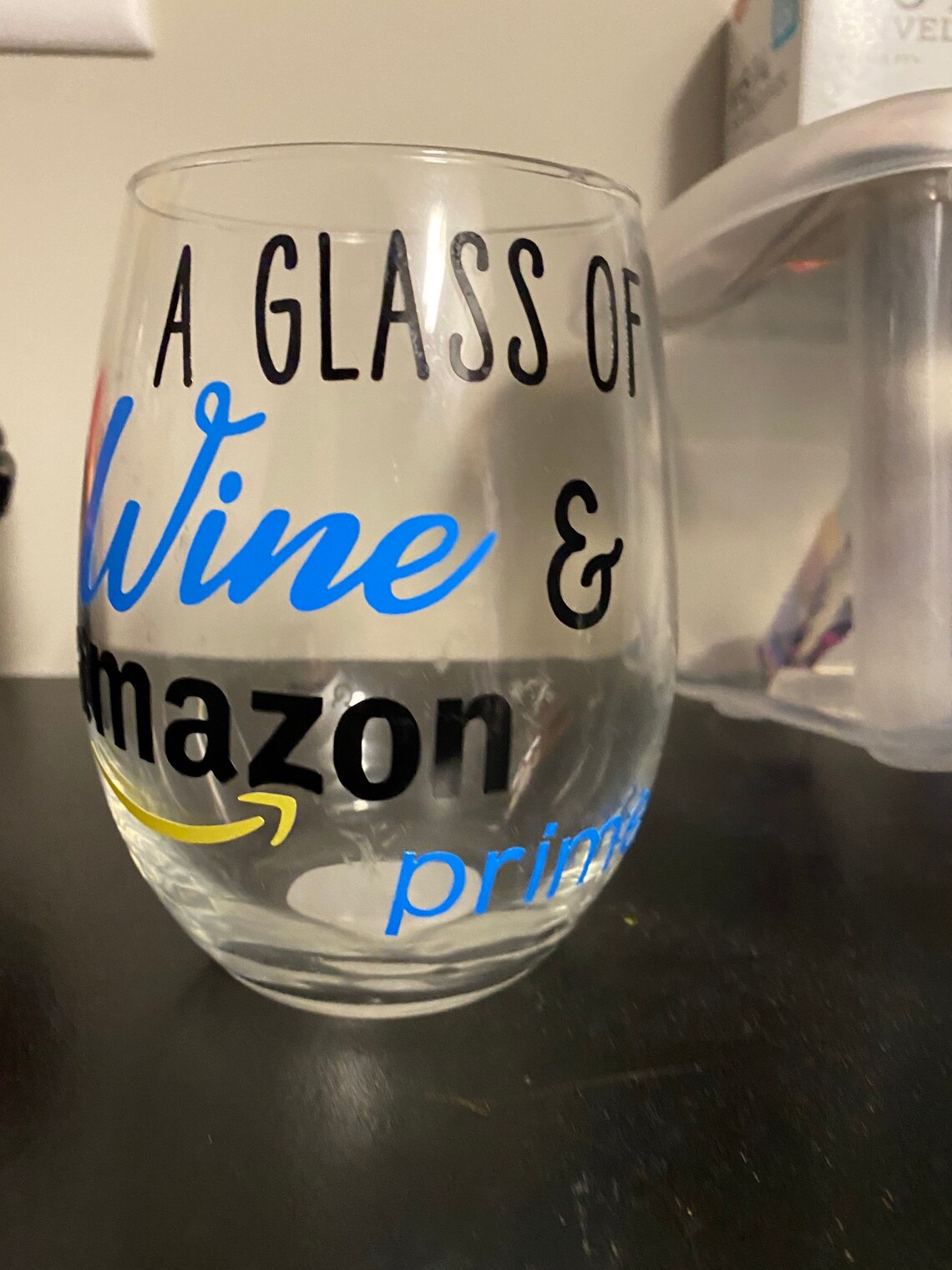 A glass of wine and Amazon prime Wine Glass Etsy