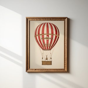 May include: A framed print of a red and white striped hot air balloon with a wooden basket. The balloon is against a white background.