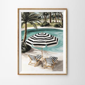 May include: A framed print of a poolside scene. A black and white striped umbrella shades two matching lounge chairs. The turquoise pool is surrounded by palm trees and lush greenery. The artwork is in a wooden frame.
