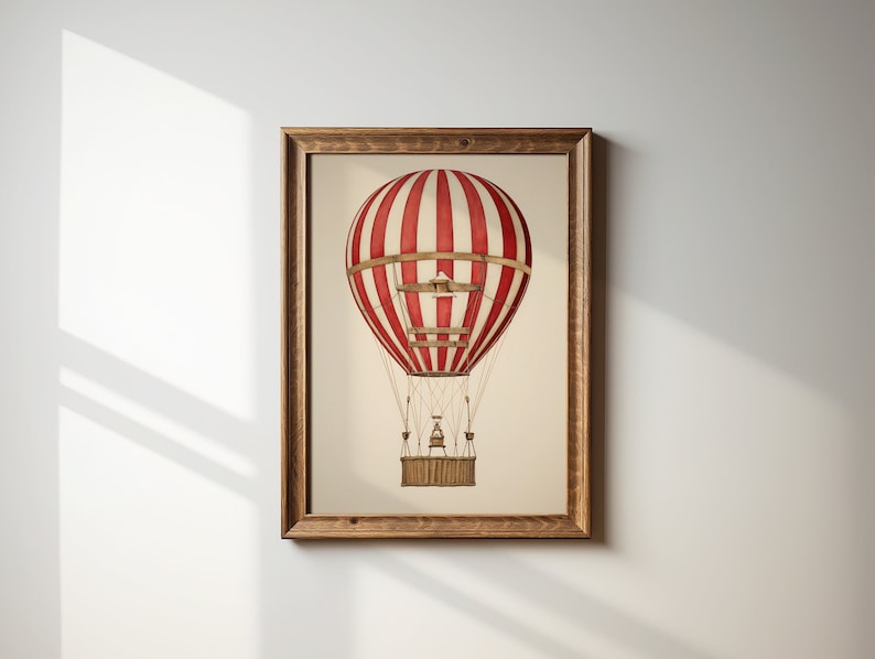 May include: A framed print of a red and white striped hot air balloon with a wooden basket. The balloon is against a white background.