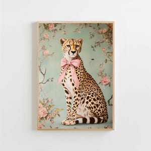 May include: A cheetah with a pink bow sitting in front of a floral background. The cheetah is looking directly at the viewer.