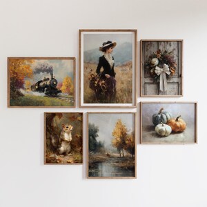 May include: A collection of framed art prints with a vintage aesthetic. The images depict a train, a woman in a field, a wreath, pumpkins, a squirrel, and a landscape with trees. The color palette includes warm tones of brown, orange, and green.