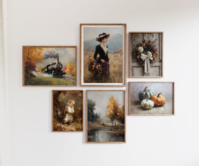May include: A collection of framed art prints with a vintage aesthetic. The images depict a train, a woman in a field, a wreath, pumpkins, a squirrel, and a landscape with trees. The color palette includes warm tones of brown, orange, and green.