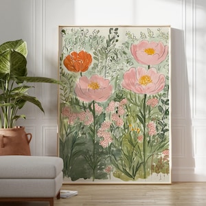 K&ouml;nnte beinhalten: Ein gerahmter Kunstdruck mit einer Gartenszene mit gro&szlig;en rosa und orangefarbenen Blumen. Das Kunstwerk hat einen Aquarellstil mit gr&uuml;nem Laub und einem hellen Hintergrund. Der Druck wird in einem Raum mit neutraler Farbpalette ausgestellt.