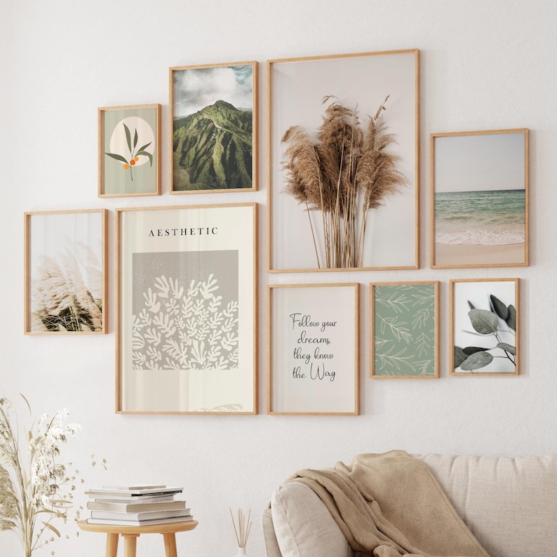 May include: A collection of framed art prints in various sizes and styles. The prints feature botanical illustrations, landscapes, and inspirational quotes. The frames are a light wood color, and the overall aesthetic is minimalist and modern.