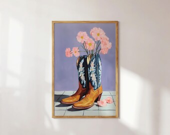 May include: A framed painting shows brown and blue cowboy boots with pink flowers. The boots have a floral design on the blue sections. The background is a light purple colour.