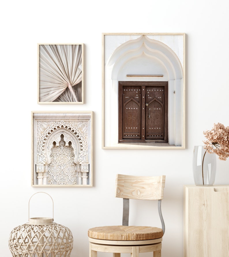 May include: Three framed prints with a Moroccan theme. The prints feature a close-up of an ornate archway, a traditional wooden door, and a palm leaf.