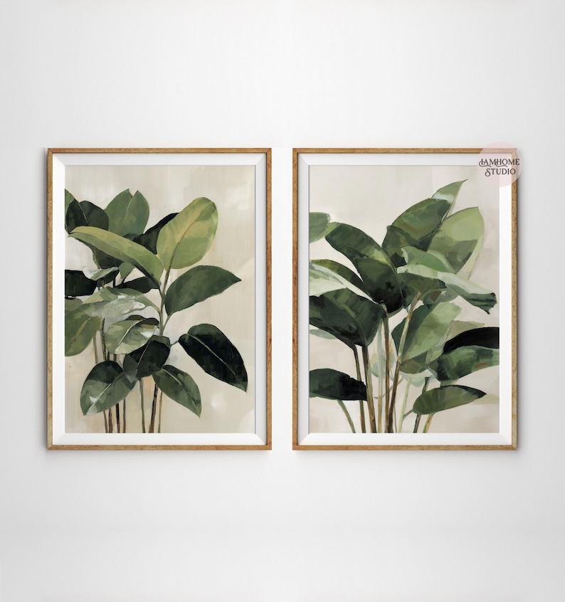 Puede incluir: Dos impresiones bot&aacute;nicas enmarcadas con exuberantes hojas verdes sobre un fondo neutro. La obra de arte tiene un efecto acuarela, con diferentes tonos de verde y marr&oacute;n. Los marcos de color marr&oacute;n claro a&ntilde;aden un toque natural a la decoraci&oacute;n.
