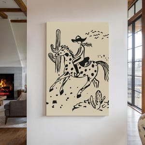 May include: Black and white illustration of a person riding a horse in a desert landscape. The person is wearing a cowboy hat and the horse has spots. There are cacti in the background.