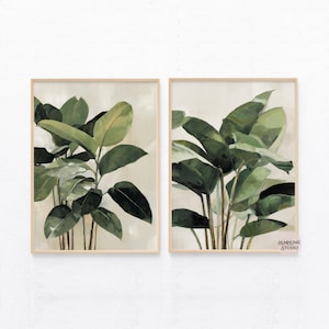 Puede incluir: Dos impresiones bot&aacute;nicas enmarcadas con exuberantes hojas verdes de plantas. La obra de arte tiene un fondo neutro y un marco de madera clara. Las hojas est&aacute;n pintadas en tonos verdes, creando una est&eacute;tica natural y relajante. Adecuado para la decoraci&oacute;n del hogar.