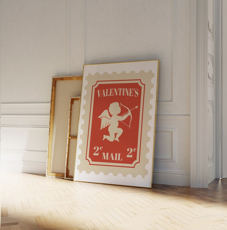 May include: A vintage-style Valentine's Day mail stamp with a red background and a white cherub holding a bow and arrow. The stamp says "Valentine's 2&cent; Mail 2&cent;".