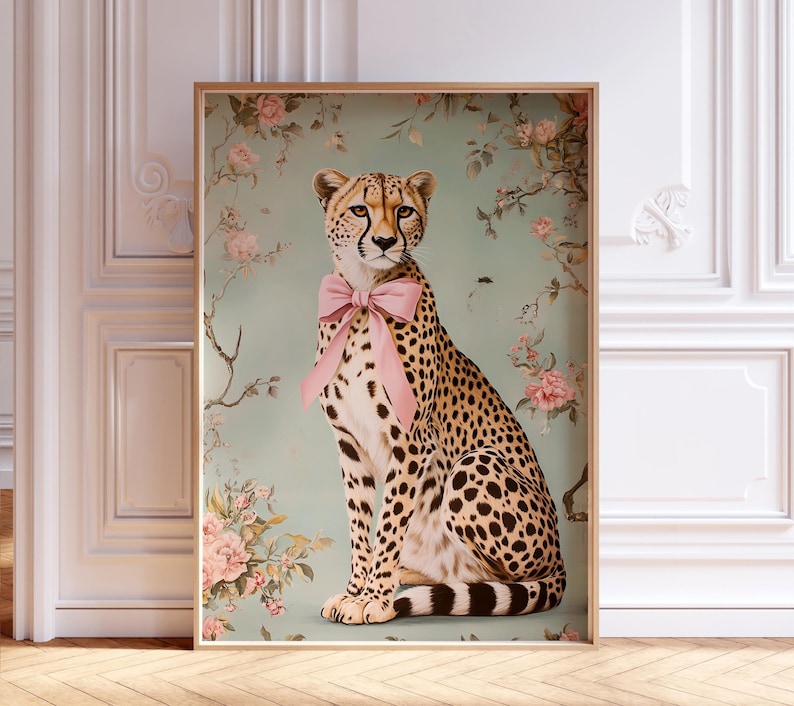 May include: A cheetah with a pink bow sitting in a floral setting. The cheetah is looking directly at the viewer. The background is a light blue-green color with pink and white flowers.