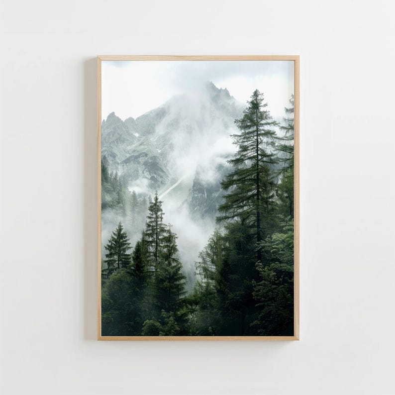 May include: A misty mountain scene with tall evergreen trees in the foreground. The mountain peaks are obscured by clouds and fog, creating a sense of mystery and tranquility.