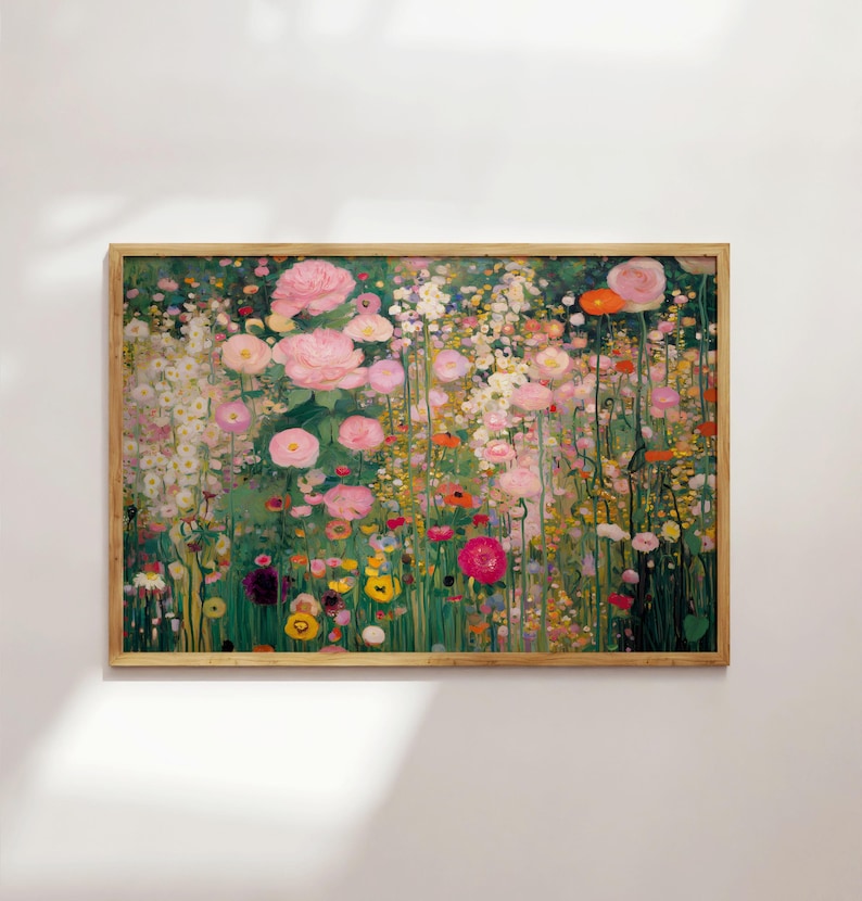 May include: A rectangular framed wall art print featuring a dense garden scene filled with numerous pink, white, yellow, and orange flowers on thin green stems. The artwork is encased in a light-toned wooden frame with a natural grain finish.
