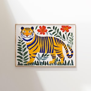 May include: A framed illustration of a yellow and blue striped tiger walking through a jungle scene with red flowers. The tiger is facing the viewer and has a friendly expression.