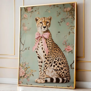 May include: A cheetah with a pink bow sitting in front of a floral background. The cheetah is looking directly at the viewer. The background is a light blue-green color with pink and white flowers.