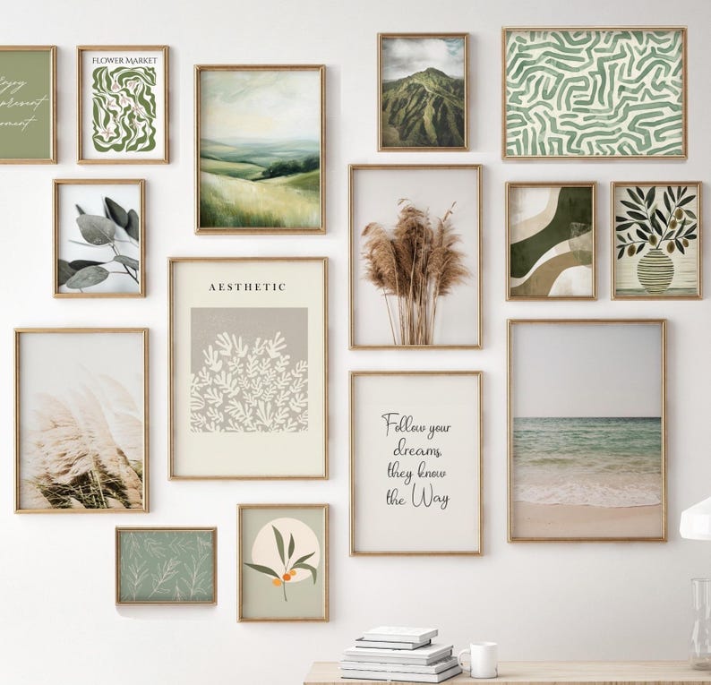 May include: A collection of framed art prints in various sizes and styles. The prints feature landscape scenes, abstract designs, botanical illustrations, and inspirational quotes. The frames are a warm gold color, and the overall aesthetic is neutral and calming.