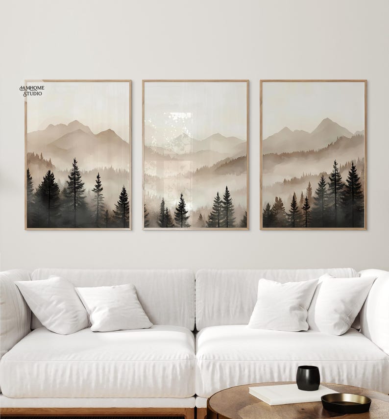 May include: A set of three rectangular wall art prints featuring a misty mountain landscape with dark evergreen trees in the foreground and light beige, hazy mountains in the background. The text JAMHOME STUDIO is visible in the top left corner.
