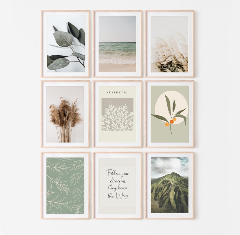 May include: Nine framed art prints with a minimalist aesthetic. The prints feature botanical illustrations, beach scenes, and inspirational quotes. The frames are light wood, and the overall color palette is neutral with green and beige accents.