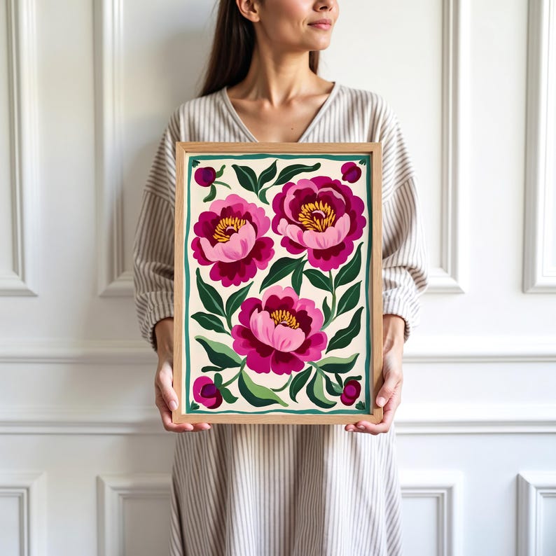May include: A framed print of a floral design featuring three pink peonies with green leaves and stems on a cream background.