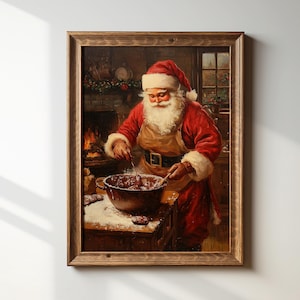 May include: A framed wall art print depicting Santa Claus with a white beard wearing a red coat and a tan apron, stirring a dark mixture in a large metal bowl on a wooden table dusted with flour, set in a room with a fireplace and a window.