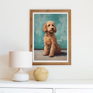 May include: A framed painting of a light brown dog sitting on a blue background. The dog is looking up and has a fluffy coat.