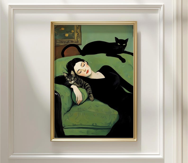 May include: A framed art print depicts a woman in a black dress reclining on a green sofa with two cats. One cat rests on the sofa, while the other is curled up next to the woman. The artwork has a vintage aesthetic with a gold frame.