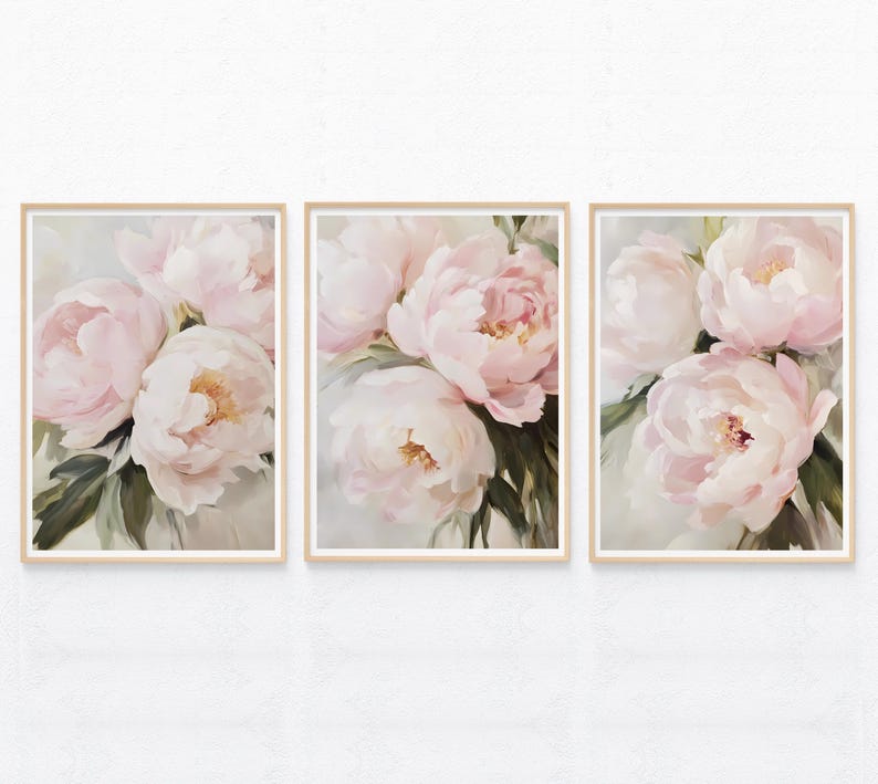 May include: Set of three framed floral art prints. Each print features a close-up of soft pink peonies with yellow centers and green leaves. The artwork is set against a light background, creating a delicate and elegant aesthetic.
