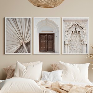 May include: Three framed prints in a bedroom setting. The prints feature a close-up of a palm leaf, a wooden door with intricate details, and a white archway with ornate carvings.