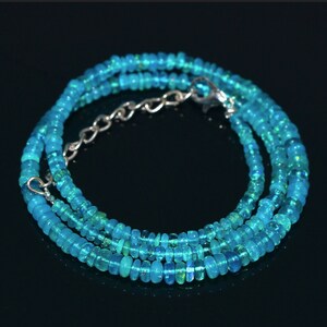 Puede incluir: Un collar de piedras preciosas de &oacute;palo azul turquesa con un cierre de plata. El collar est&aacute; hecho de peque&ntilde;as cuentas redondas y est&aacute; en capas para un look delicado.
