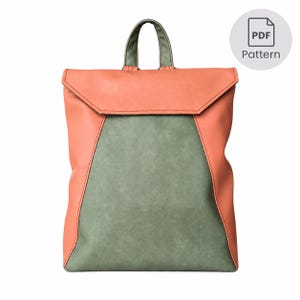 May include: A backpack featuring a sage green central panel and coral orange side panels with a matching coral orange fold-over flap and a sage green top handle. A circular icon in the top right corner displays the text PDF Pattern.
